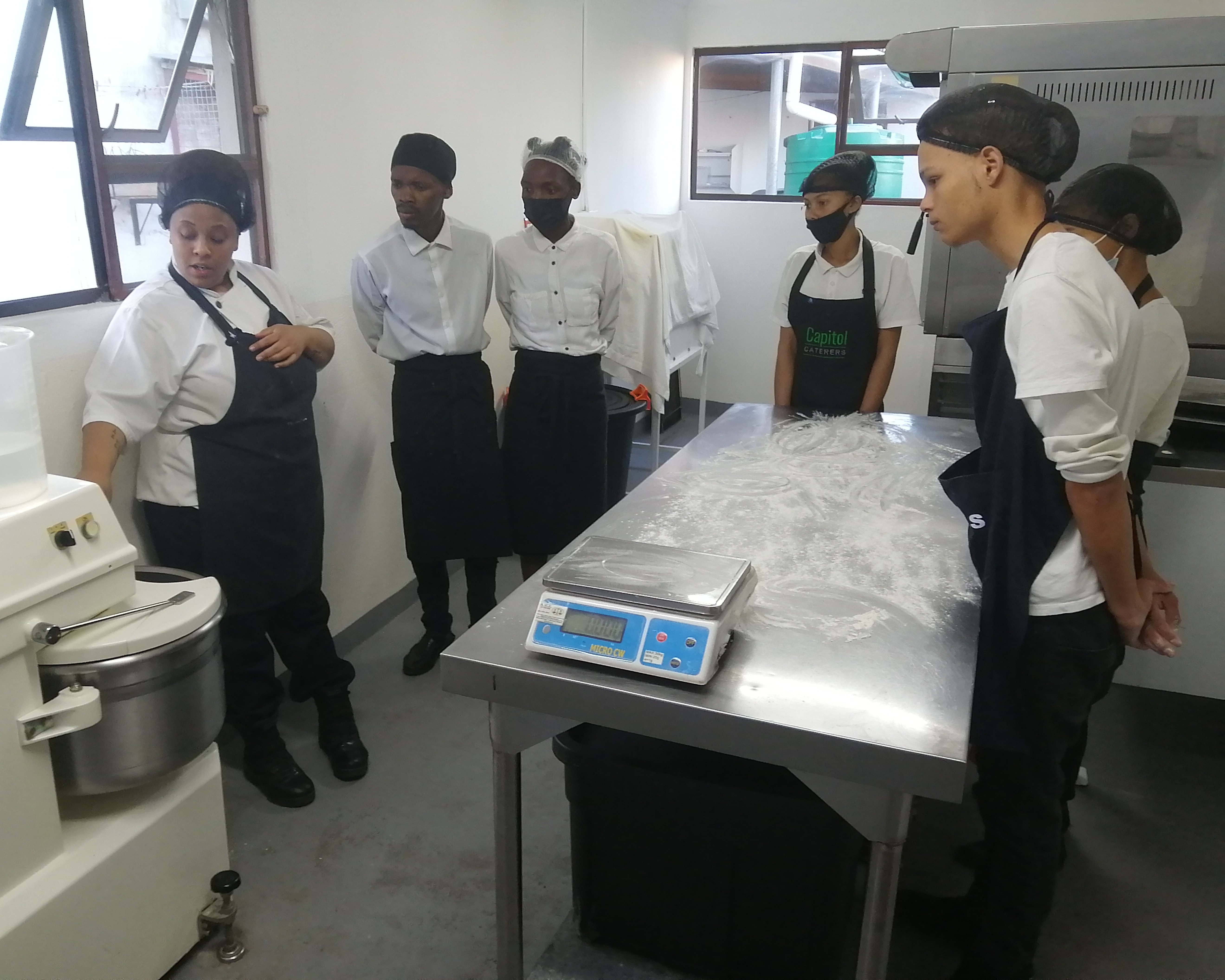 A group of women in chef aprons
